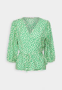 Haut cache-cœur à fleurs vertes avec manches bouffantes, col en V et taille à cordon. Présente de petites fleurs vertes sur un fond vert clair.