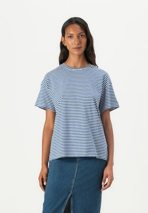 Blue and white striped t-shirt with short sleeves and a round neckline, paired with a denim skirt featuring a front slit detail.