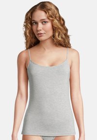 Gray tank top with thin adjustable straps, made from a soft, stretchy fabric. Features a fitted shape and a simple, clean neckline.