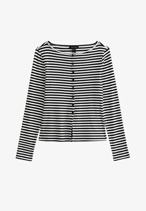 Haut à rayures horizontales noires et blanches, manches longues, boutonné sur le devant avec un col rond et de petits boutons noirs.