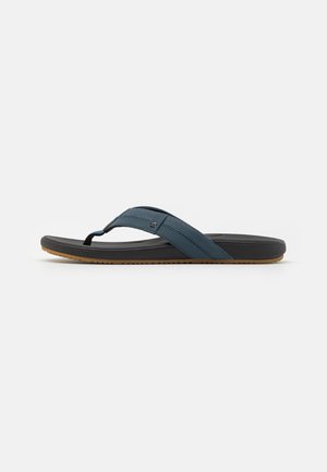 Flip-flop sandal with a dark blue synthetic strap, black cushioned sole, and textured brown outsole. Features a toe post design.