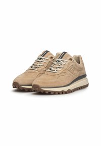 Jasnobrązowe zamszowe sneakersy o fakturowanej powierzchni, gumowej podeszwie zapewniającej przyczepność, czarnych akcentach, grubych sznurowadłach oraz podniesionym logo marki na boku.