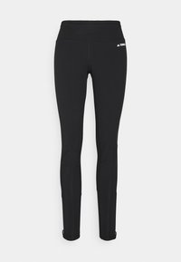 Leggings neri realizzati in tessuto elasticizzato con una fascia larga in vita, dotati di un logo all'anca e aperture alla caviglia per una vestibilità sicura.