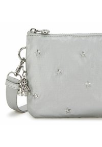 Light grey fabric pouch with silver star embellishments, zip closure, and a detachable silver charm. Includes a matching strap.