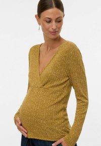 Sinise ribidega mähkmetop, sinepikollane, sügava V-kaelusega, pikkade varrukatega ja kitseneva vöökoha ning mugavuse ja istuvuse toetamiseks raseduse ajal.