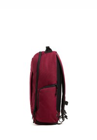 Red fabric backpack with a sleek design, featuring black accents, padded back, mesh side pocket, and zippers on the front for additional storage.