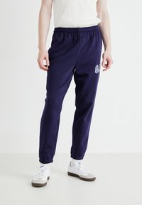 GAP TONAL ARCH JOGGER - Treniņtērpa apakšdaļas - navy uniform