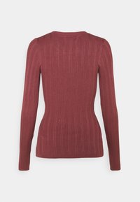 Long-sleeve ribbed sweater in a rich burgundy color, featuring a fitted silhouette and a soft texture. Back view showcases vertical stripes.