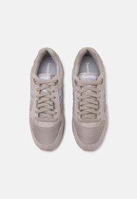 Gray suede and mesh sneakers with a rounded toe, lace-up design, and silver accents. Logo visible on the tongue and sides.