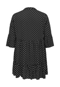 Schwarzes Kleid mit Tupfenmuster, das einen ausgestellten Saum und lange Ärmel aufweist, gefertigt aus weichem Stoff mit einem leichten, fließenden Design.