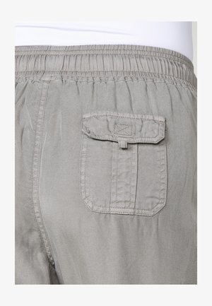 Graue Hosen mit weicher Textur, elastischem Bund und einer einzelnen rechteckigen Gesäßtasche. Detaillierte Nähte und subtiler Glanz sind sichtbar.
