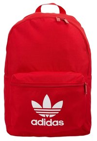 Red backpack featuring a matte finish, dual zippered main compartment, front pocket, and a prominent white Adidas logo with three leaf design.