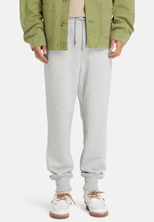 Lichtgrijze sweatpants gemaakt van een zachte katoenmix, met een elastische tailleband, taps toelopende boorden en zijzakken.