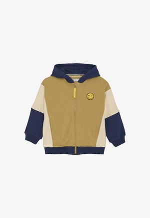 Felpa con zip per bambini con blocchi di colore beige, senape e blu navy, cappuccio blu navy, tasche frontali e una piccola patch a forma di faccina sorridente gialla sul petto.
