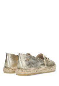 Zapatos espadrilles metálicos dorados con acabado texturizado, suela de yute tejido y forma redondeada, con un pequeño detalle del logo en el lateral.