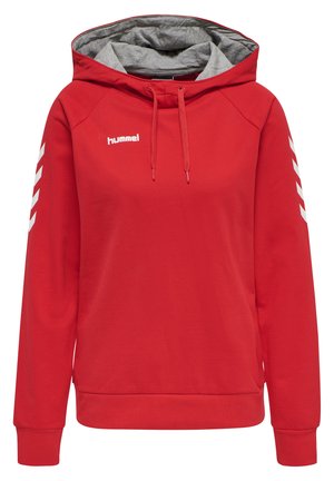 Sweat à capuche rouge avec un intérieur gris, comportant une poche avant, un cordon de serrage et des motifs chevrons blancs sur les manches. Logo Hummel sur la poitrine.