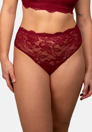 Woman wearing high-waist burgundy lace underwear and matching bra, showing floral patterns and scalloped edges.