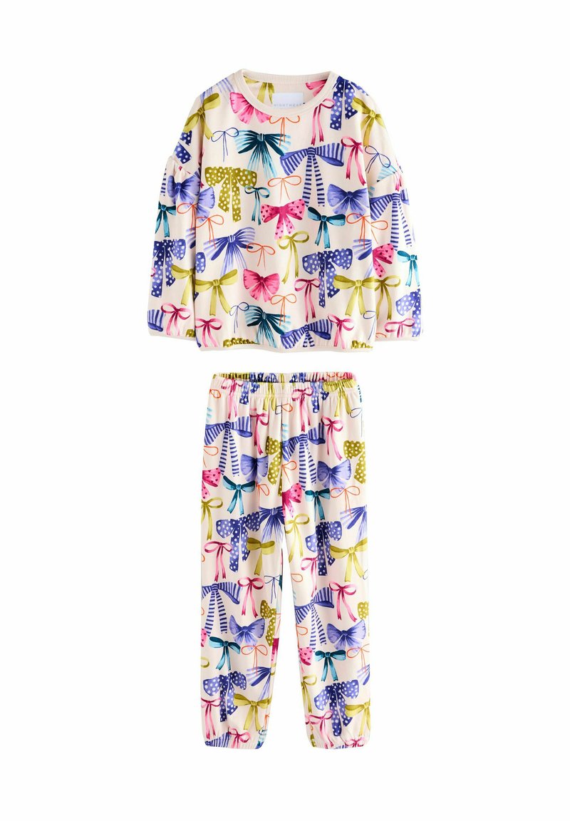 Ensemble de pyjama deux pièces en tissu doux, présentant un imprimé coloré de nœuds et de pois en rose, violet, vert et jaune sur un fond crème.