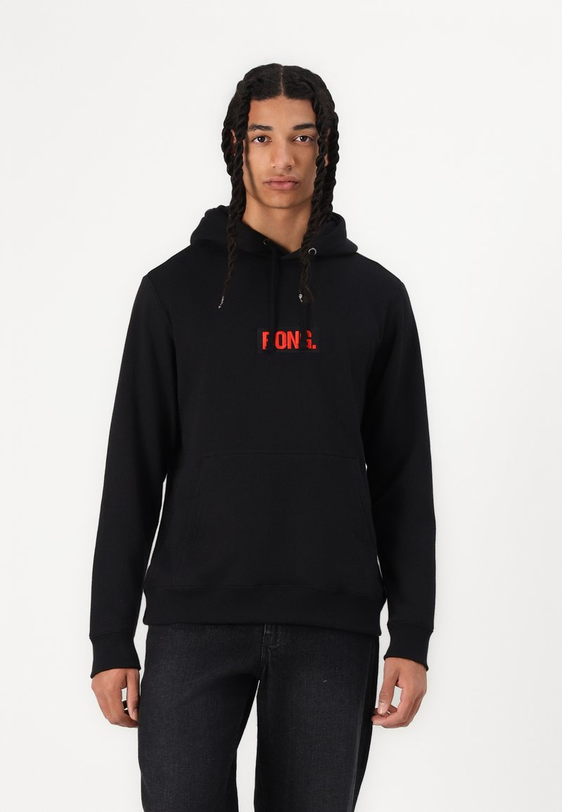 Black hoodie made of cotton with a front pocket and drawstring hood. Features a red logo appliqué on the chest. Casual fit and texture.