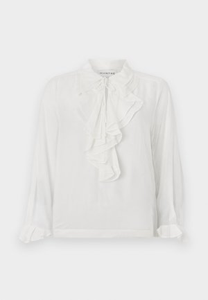Vit långärmad blus med volangdetaljer fram, hög krage och samlade ärmändar. Tillverkad av lätt tyg som ger en mjuk känsla.
