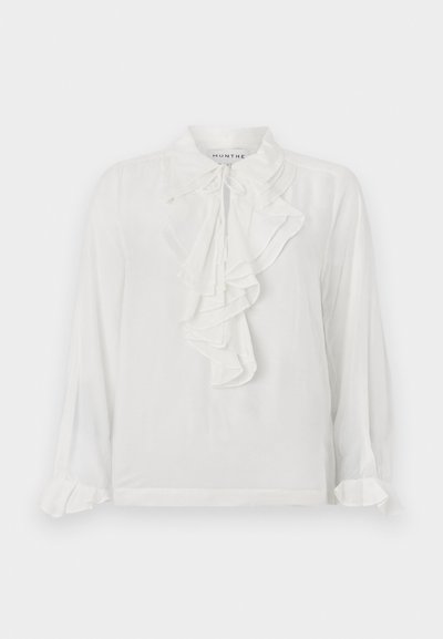 White long-sleeve blouse with ruffled front detailing, high collar, and gathered cuffs. Made of lightweight fabric, offering a soft texture.