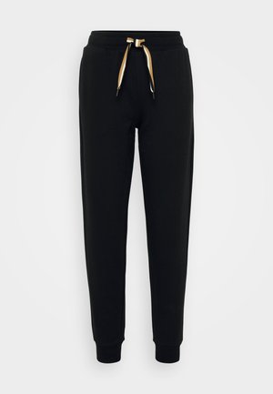 Black sweatpants made from soft fabric, featuring a tapered fit, elastic waistband, and contrasting drawstring with gold and white stripes.