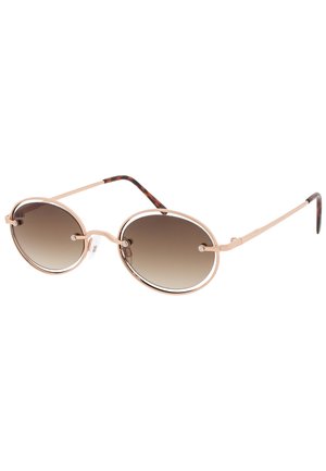 Gafas de sol redondas con un marco metálico dorado, lentes marrones degradados y acentos de carey en las patillas. Incluyen almohadillas nasales texturizadas.
