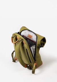 Zaino verde oliva con accenti in pelle marrone chiaro, dotato di più scomparti, design a risvolto e una fodera interna texture.