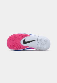 Athletisk sko sål med blandede lyserøde og hvide knopper, sort Nike swoosh i midten og blå øverste kant synlig.