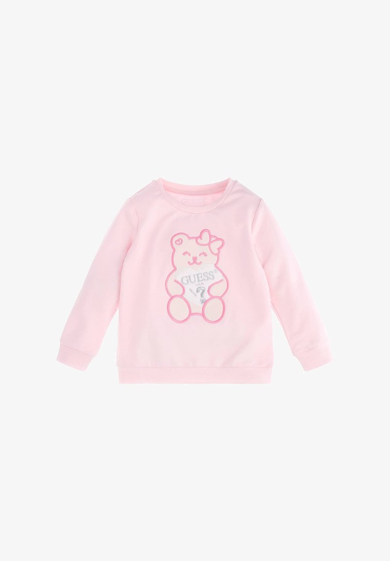 Felpa rosa realizzata in morbido materiale, caratterizzata da una grafica di orso con un fiocco e un logo a forma di cuore, contorni a contrasto e maniche lunghe.