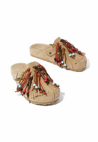 Smeđe suede slip-on cipele s resicama, s smešnim, crvenim i plavim perlama. Mekana tekstura i zaobljen dizajn prstiju. Neprijanjajući potplat.