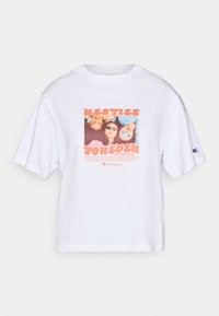 White short-sleeve T-shirt featuring a colorful photo graphic adorned with the text "BESTIES FOREVER," and a Champion logo on the sleeve.