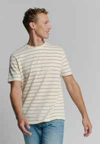 Gestreiftes kurzärmliges T-Shirt in Creme mit beigen Streifen, aus leichtem Stoff; Rundhalsausschnitt, lockere Passform und weiche Textur.