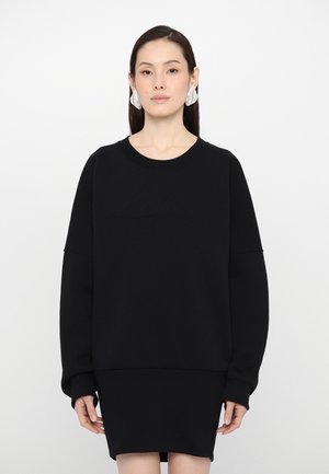 Black sweatshirt with long sleeves and a round neckline, featuring a textured logo on the front. Soft, smooth fabric with a relaxed fit.