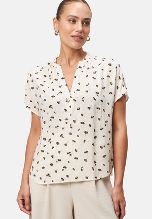 Blusa cremisi a maniche corte con scollo a V, caratterizzata da un motivo floreale con piccole foglie rosa, gialle e verdi, realizzata in tessuto leggero.