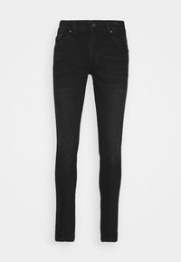 Svarta slim-fit jeans med framknapp och fickor, visade mot en enfärgad vit bakgrund.