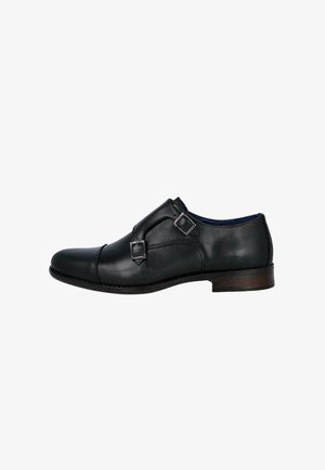 Zapato de vestir para hombre de cuero negro con hebillas dobles tipo monk strap y tacón bajo de madera, mostrado de perfil.