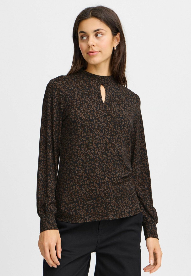 Ilga juoda bliuska su gėlių raštu rudos spalvos atspalviais. Yra skylutė kaklo linijoje ir elastingos rankogaliai. Minkštas audinio tekstūros.