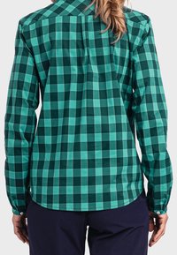 Green and teal checkered long-sleeve shirt with a button-down collar, featuring a rounded hem and single button cuffs. Smooth fabric texture.