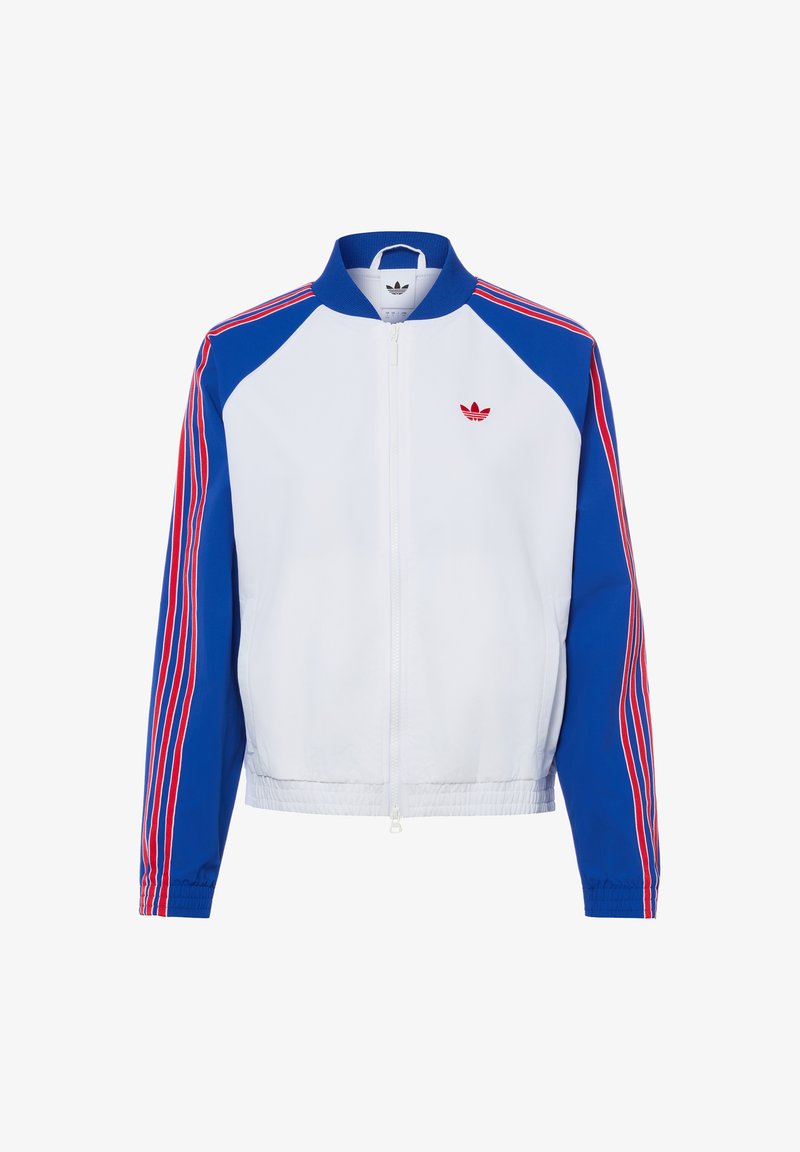 Veste de sport blanche à fermeture éclair avec manches bleues comportant des bandes rouges et blanches et un petit logo Adidas rouge sur la poitrine.