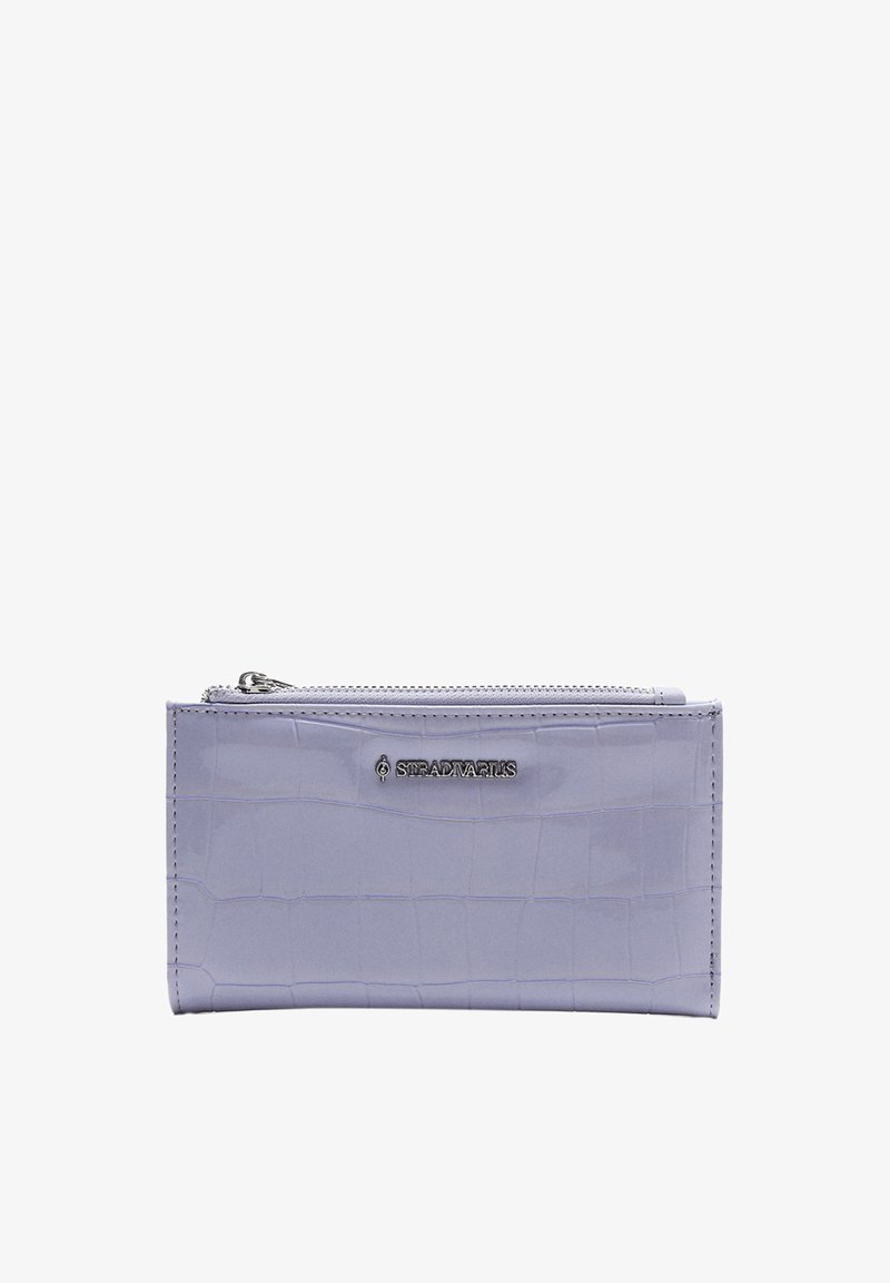 Lilac-colored wallet with a textured crocodile pattern, featuring a zip closure and a metallic logo accent. Smooth, glossy finish.