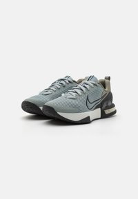 Mesh athletic shoes in light gray and black. Features a rounded toe, flat laces, padded collar, and a textured rubber outsole.
