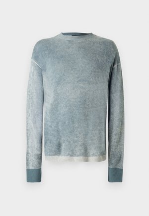 Sweater in soft, blended blue-gray fabric with long sleeves, ribbed cuffs, and a round neck. Features a slightly faded texture.
