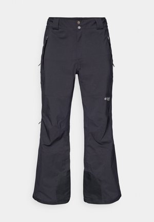 Fekete vízálló hónaaszony, egyenes szárú kialakítással, megerősített alsó szélekkel, két oldalsó zsebbel és logó részlettel a bal lábon.