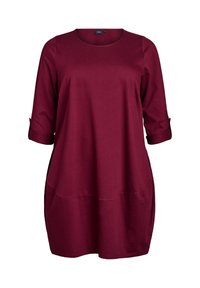 Bordeaux tuniek top gemaakt van zachte stof, met een ronde halslijn, driekwart mouwen en twee voorkanten met een relaxte pasvorm.