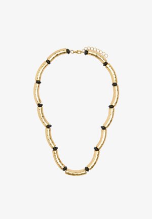 Złota metalowa naszyjnik z wydłużonymi, młotkowymi ogniwami, przeplatany okrągłymi czarnymi akcentami, wyposażony w regulowany łańcuszek z zapięciem.