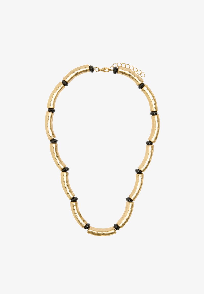 Złota metalowa naszyjnik z wydłużonymi, młotkowymi ogniwami, przeplatany okrągłymi czarnymi akcentami, wyposażony w regulowany łańcuszek z zapięciem.