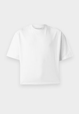 T-shirt blanc uni à manches courtes et coupe courte avec un col rond, présenté sur un fond gris clair plat.