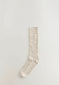 Beige stribet strømpe med en tekstureret finish, der har forstærkede hæl og tå, samt et design i mellemlang længde. Letvægtsmateriale.