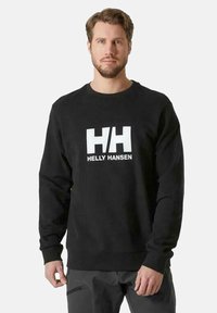 Černá mikina s kulatým výstřihem, dlouhými rukávy a bílým logem "HH" a textem "HELLY HANSEN" na přední straně. Měkká textilie.